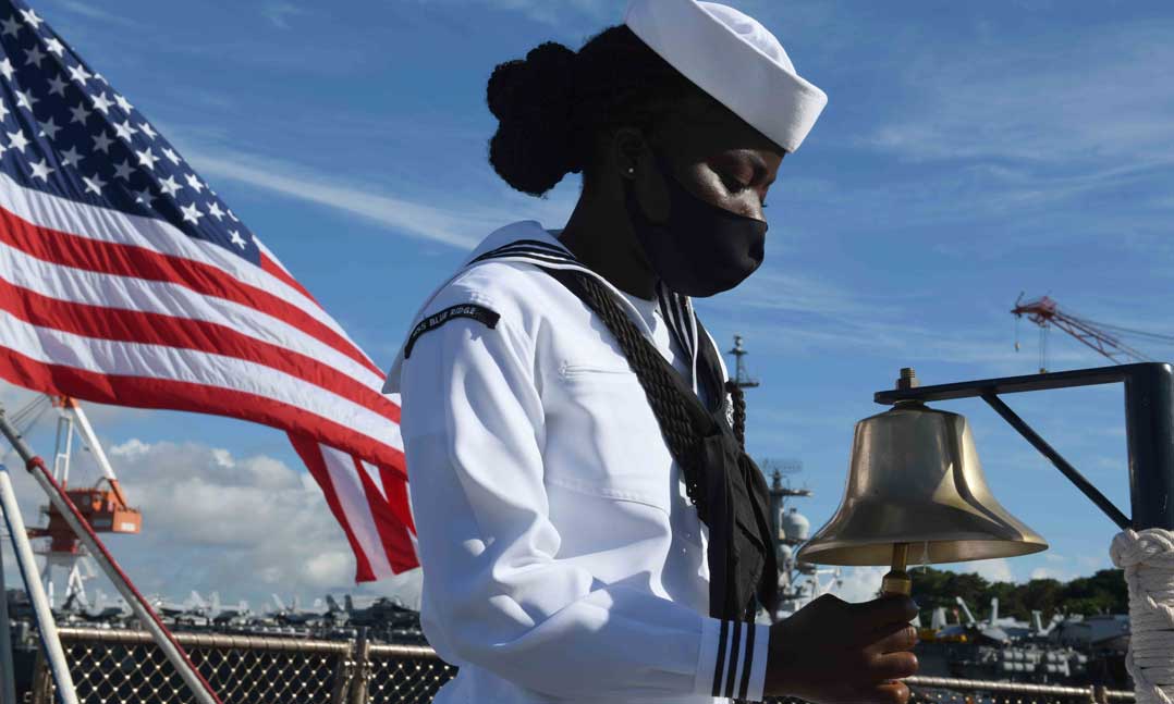 Navy Seaman Ella Koudaya rings two bells during last year’s Sept. 11 remembrance ceremony on the main deck of the USS Blue Ridge (LLC-19) in Yokosuka, Japan, Sept. 11, 2020