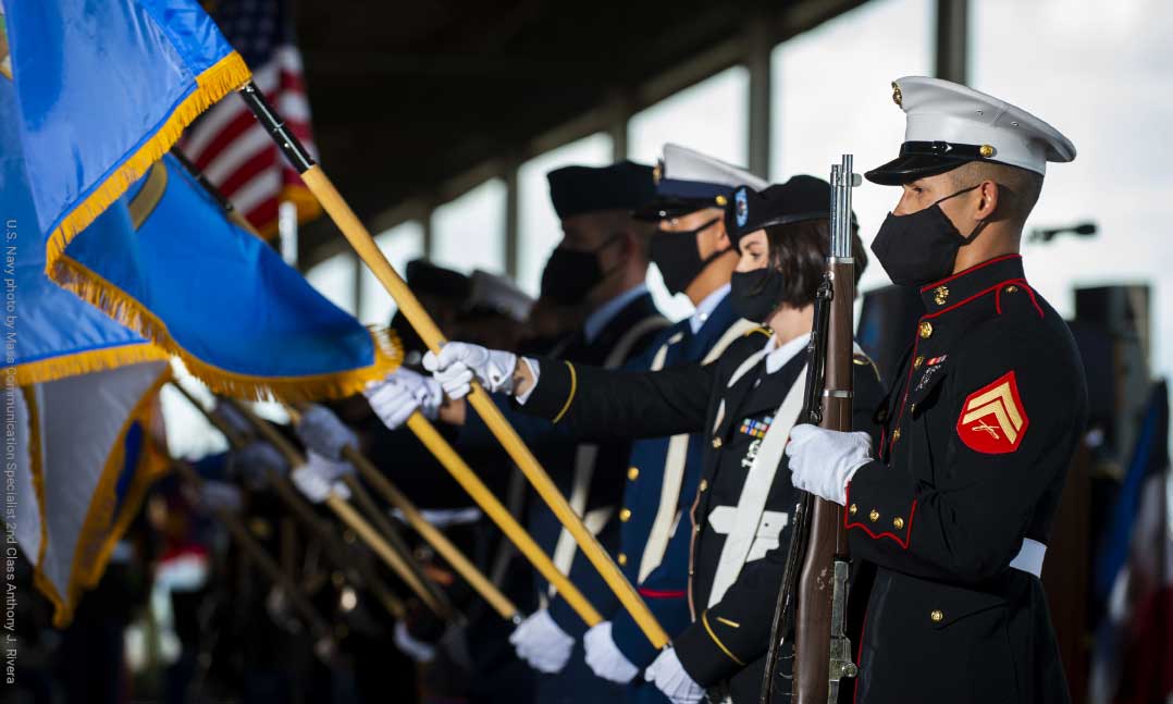 A joint-service color guard stands at attention