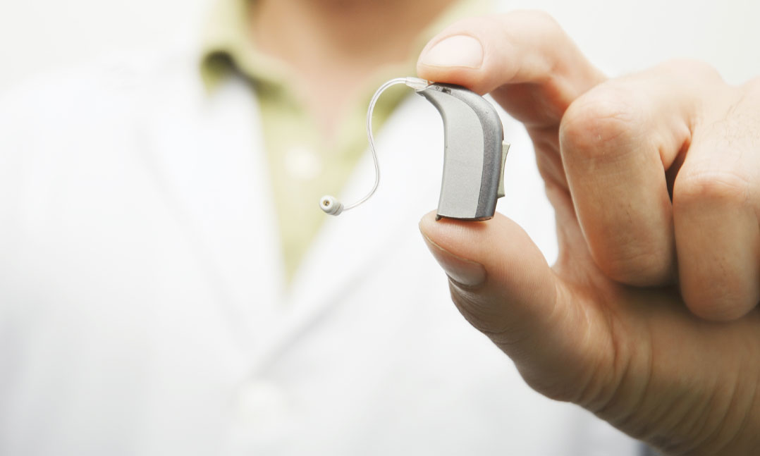 ear doctor holding a hearing aid