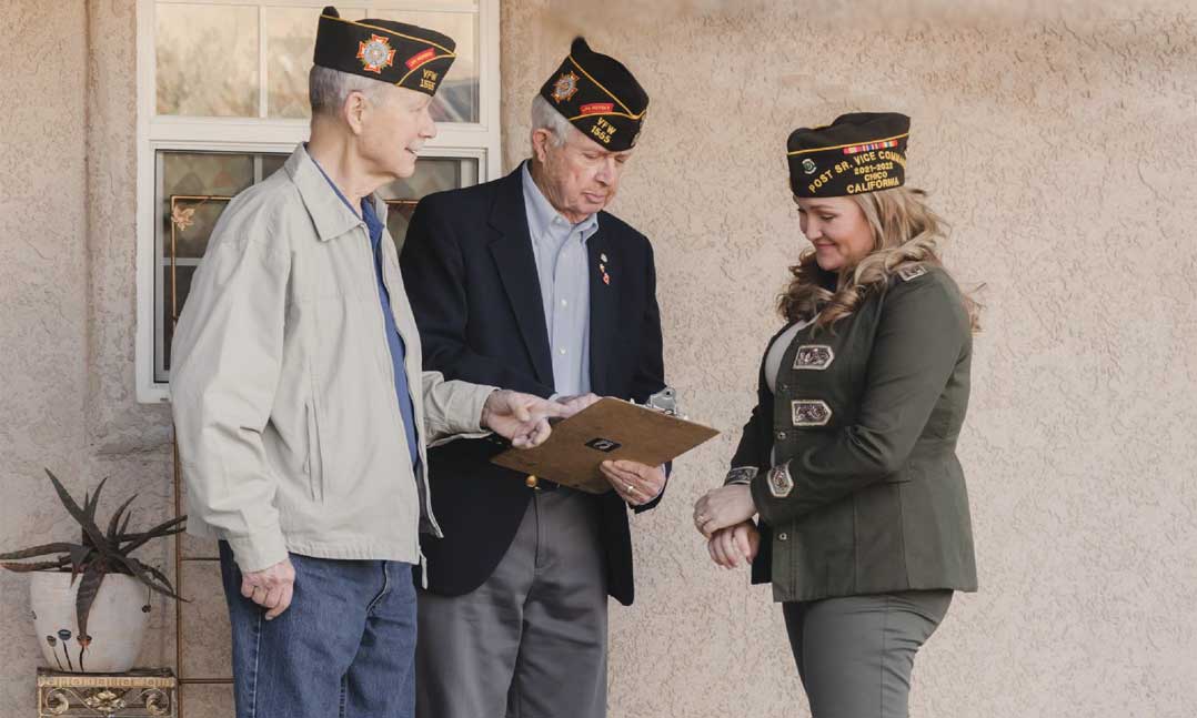 VFW members stand in front of a house that was purchased to house homeless veterans