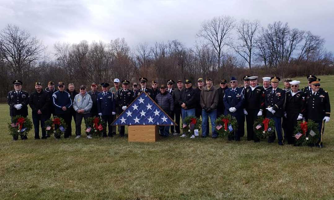 Members of VFW Post 10380 gather after laying 500 wreaths