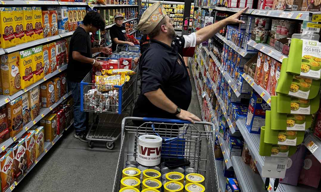 Volunteers from VFW Post 5423 and its Auxiliary collect food on Aug. 31 for the Bear Necessities Pantry