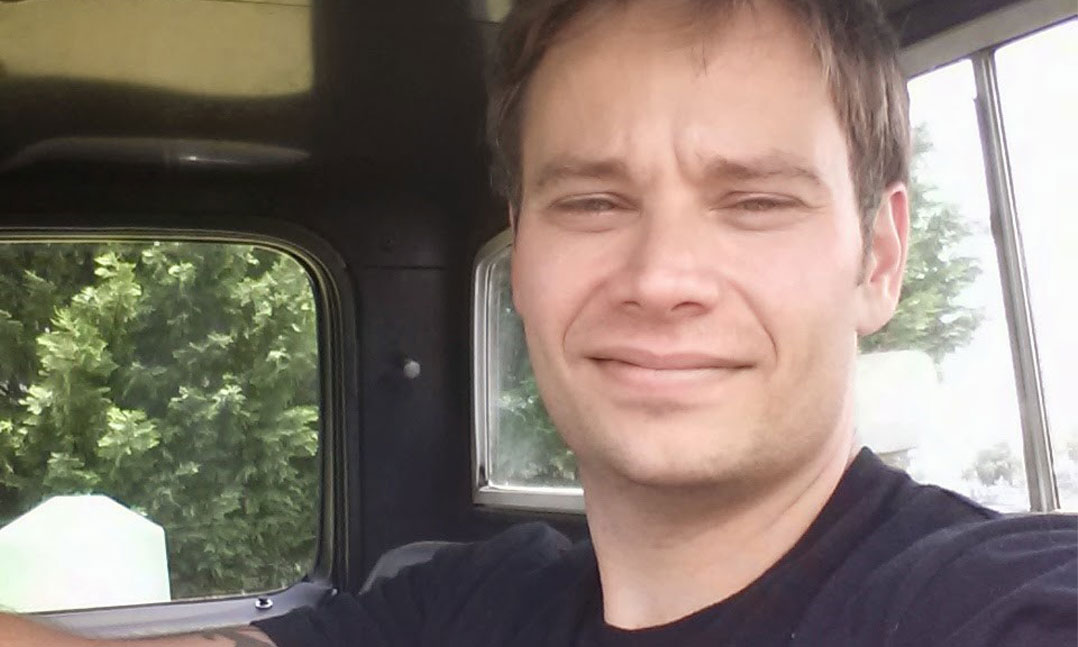 Male veteran sits behind the steering wheel of his truck