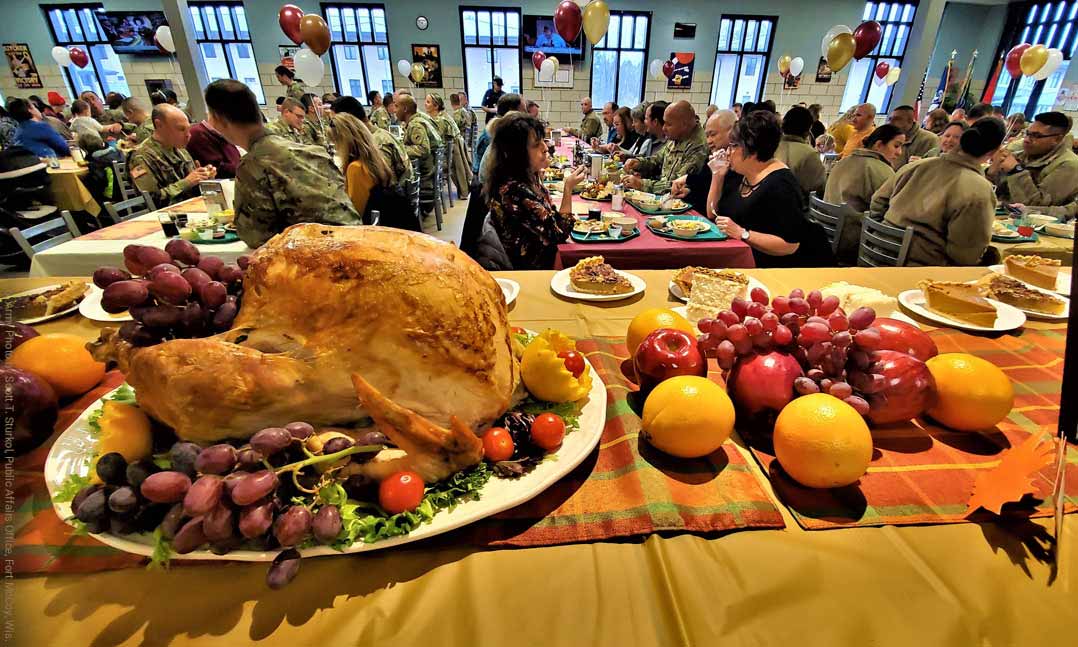 A Thanksgiving turkey sits on a table as service members enjoy a Thanksgiving meal together at Fort Irwin