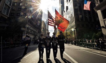 Marine Corps color guard march down the street in New York