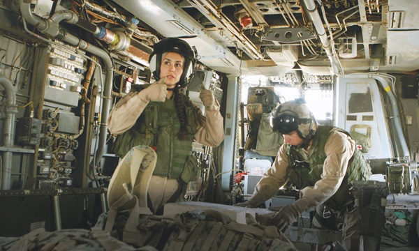 Woman service member gives the go ahead sign to crew