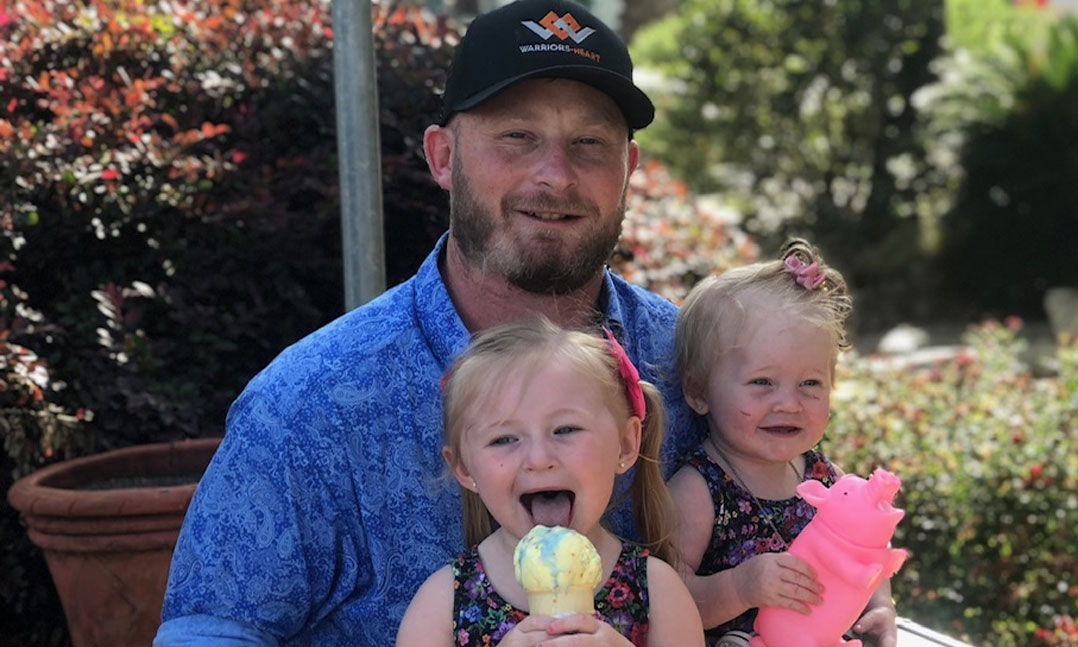 Veteran with his two daughters