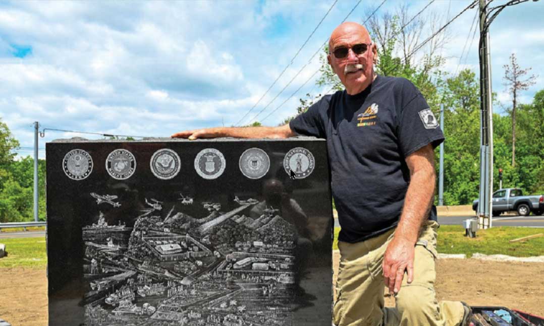Vietnam veteran Gerry Wright stands beside an Agent Orange mural
