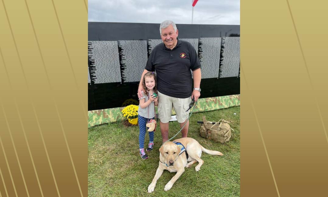 Marine Corps veteran Larry Jordan with his service dog Koz