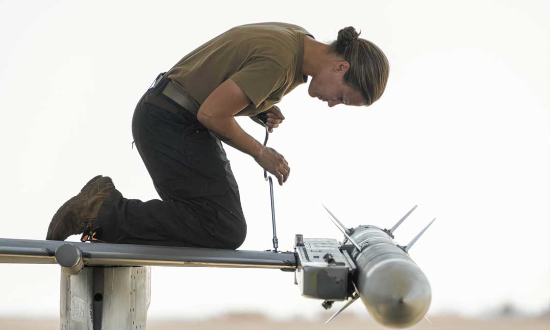 An airman performs maintenance on an F-16C Fighting Falcon at King Faisal Air Base, Saudi Arabia, Dec. 1, 2020