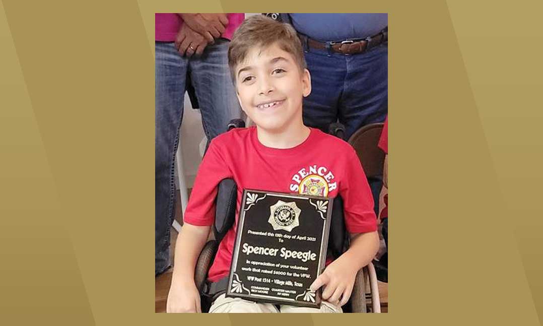 Spencer Speegle, 10, accepts an award in April at VFW Post 1514 in Village Mills, Texas, for his fundraising effort