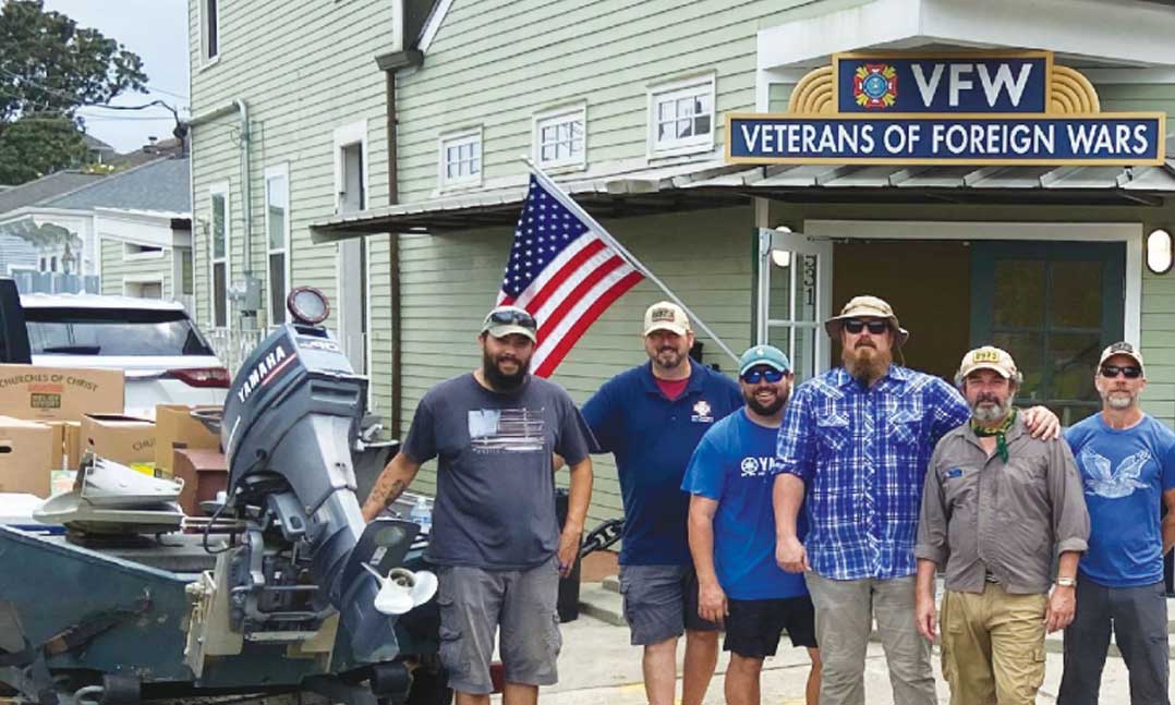 Members of VFW Post 8973 prepare boats outside of the Post near downtown New Orleans to help transport supplies during Hurricane Ida