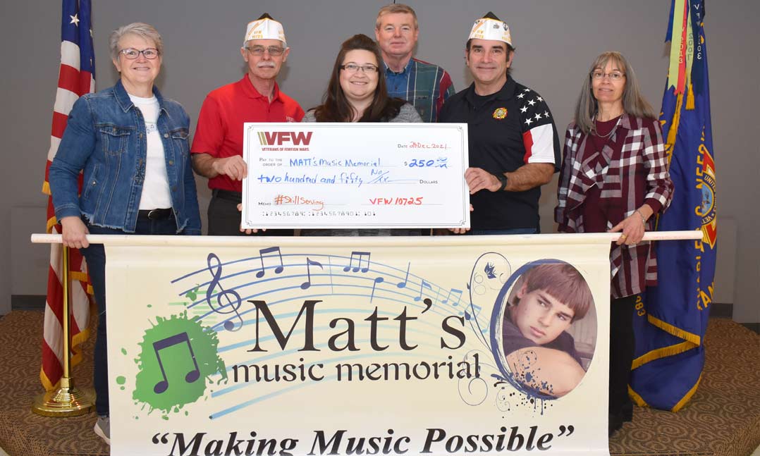 Members of VFW Post 10725 in Gretna, Neb., present a $250 check to Kara Alexander, president of the nonprofit Matt’s Music Memorial