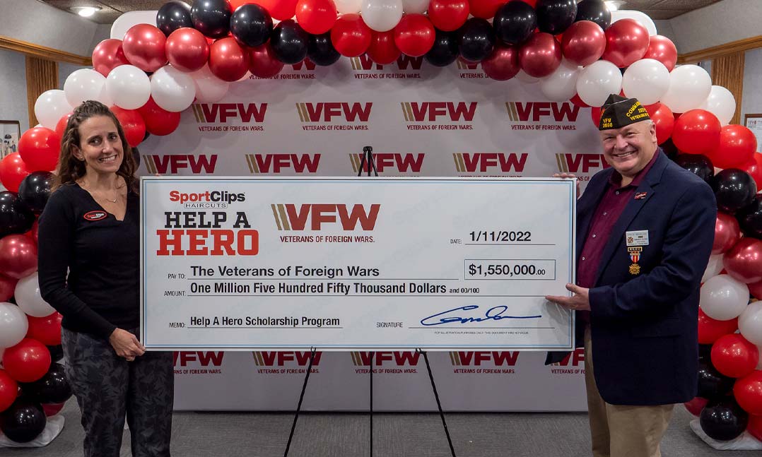Sport Clips presents the VFW with a check for $1.55 million to support the Help A Hero Scholarship program
