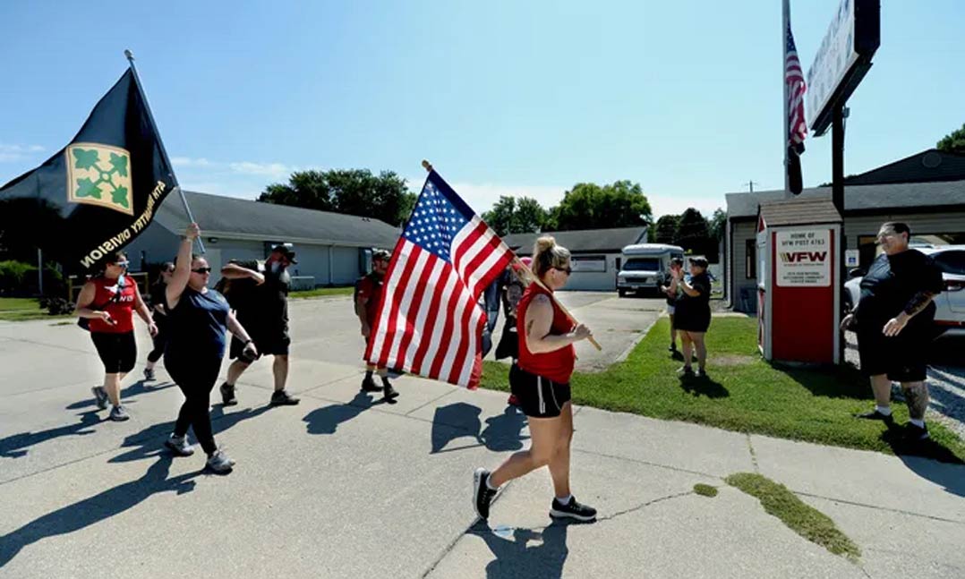 People participate in a ruck march to help veterans