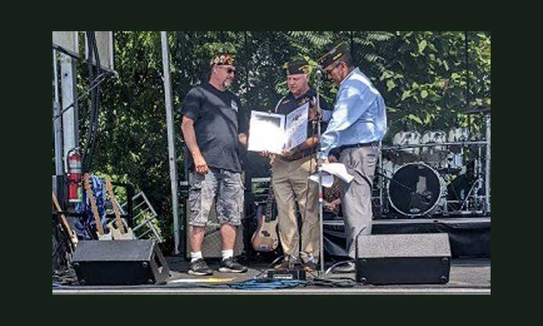 VFW Post 988 Commander Joe Garrison (left) being given the Century Award 