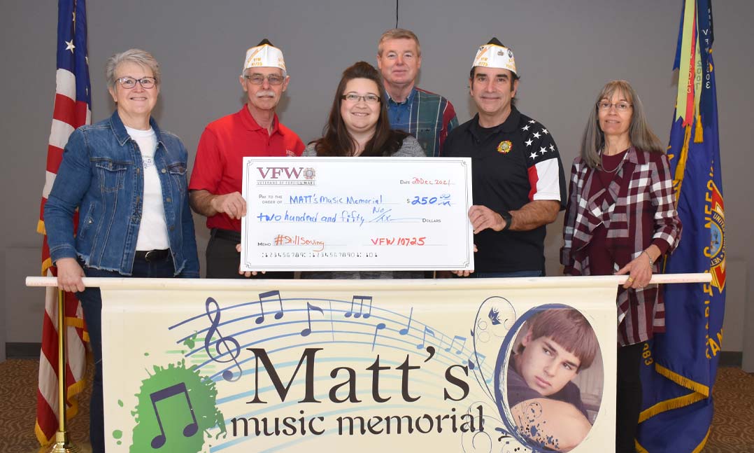 Members of VFW Post 10725 in Gretna, Neb., present a $250 check to Kara Alexander, president of the nonprofit Matt’s Music Memorial