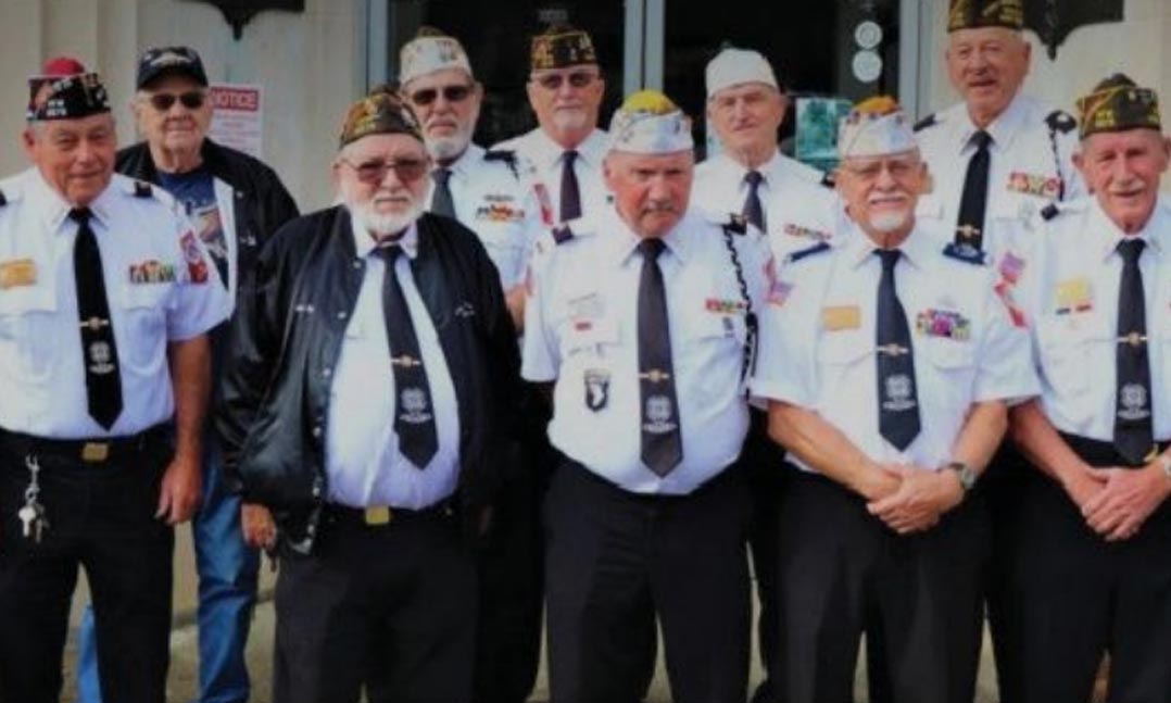 Members of VFW Post 5578 in Madison, W.Va., stand in front of their building