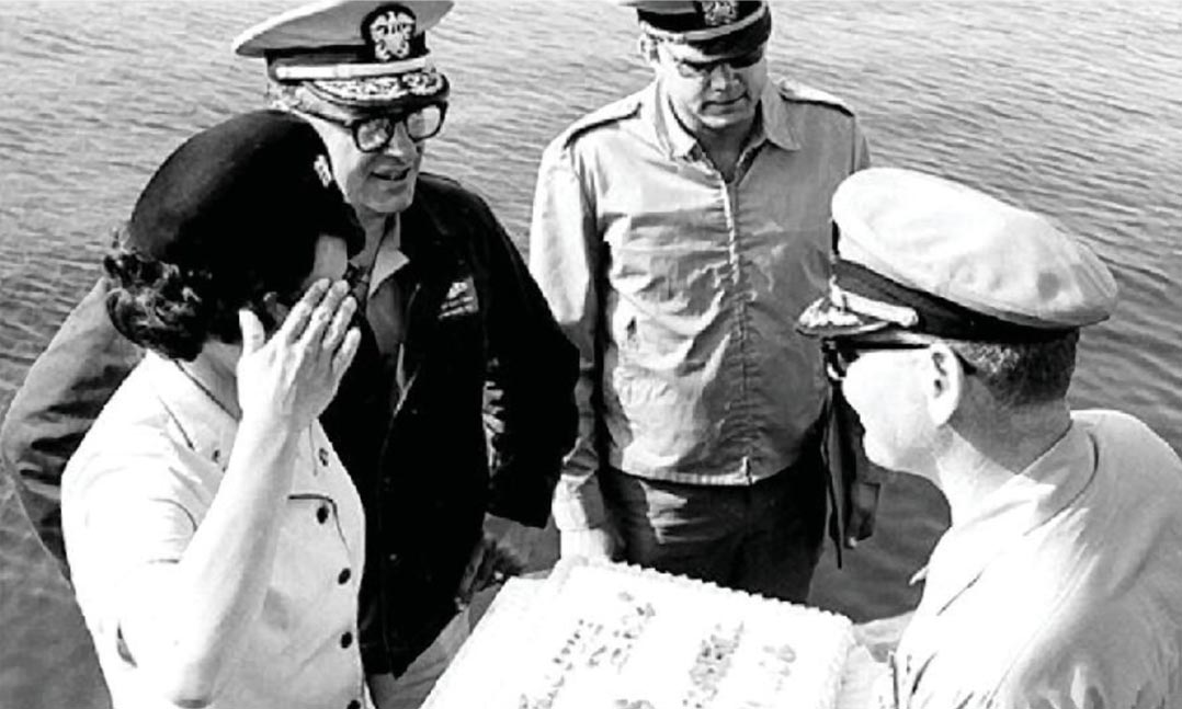 Ensign Raquel Roybal salutes the commander of the USS Hawkbill (SSN-666) in 1974 during the Hawkbill’s arrival in San Diego, Calif., while Adm. Carlisle Trost, left, and Lt. Randy McWilliams look on.