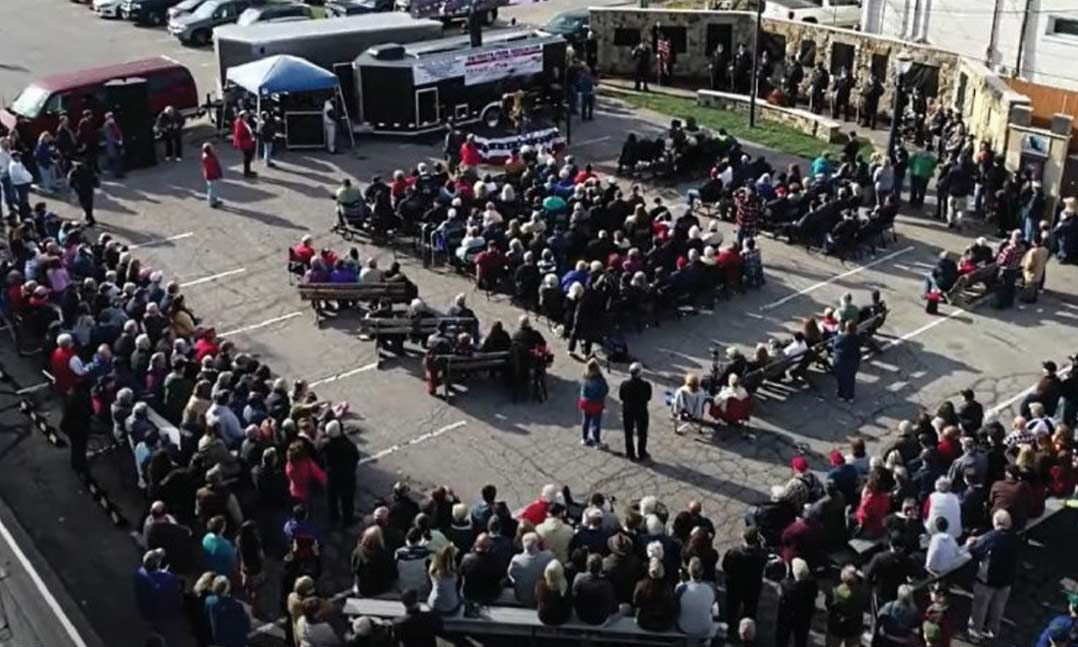 Hundreds of spectators attend a ceremonial unveiling of the Patriots Park veterans mural on Veterans Day 2021 in Amherst, Ohio.