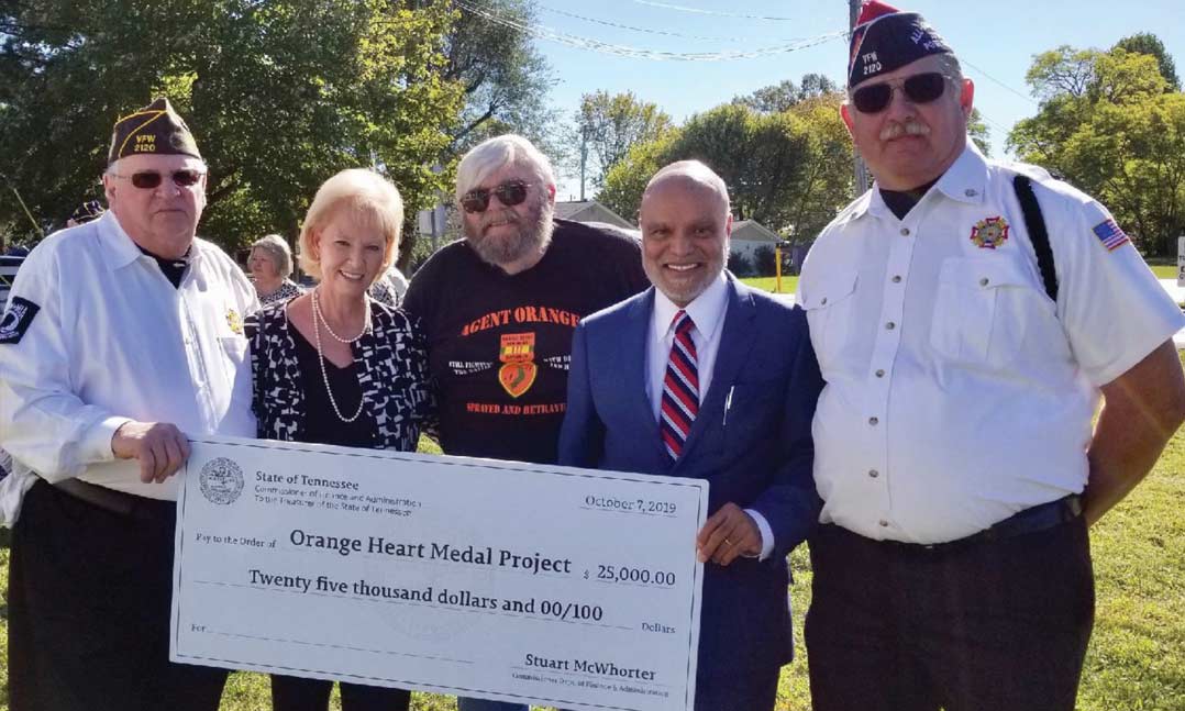 Bill Correll, LindaKumar, Ken Gamble, Sabi Kumar and Scott Lybarger pose during a $25,000 check presentation to the Orange Heart Medal Project on Oct. 7, 2019, at the White House Inn Museum in White House, Tennessee.