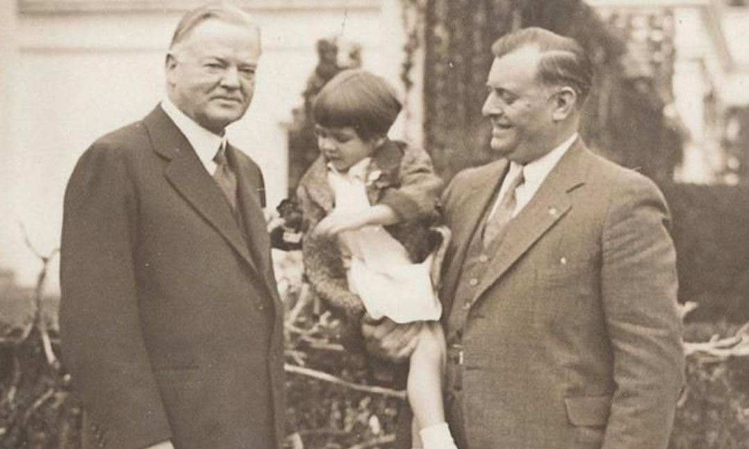 Two men and a young girl smiling