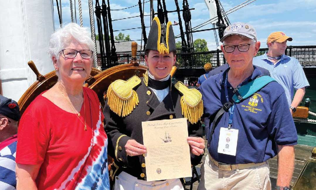 (From left) Susan Gardner, skipper of the USS Constitution Cmdr. Billie Farrell and Navy Vietnam War veteran Jack Gardner pose for a picture on June 17, 2022, aboard the USS Constitution at Massachusetts’ Boston Navy Yard.