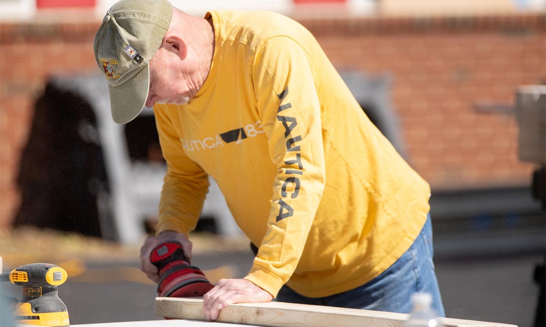 Veteran sanding during a community service project