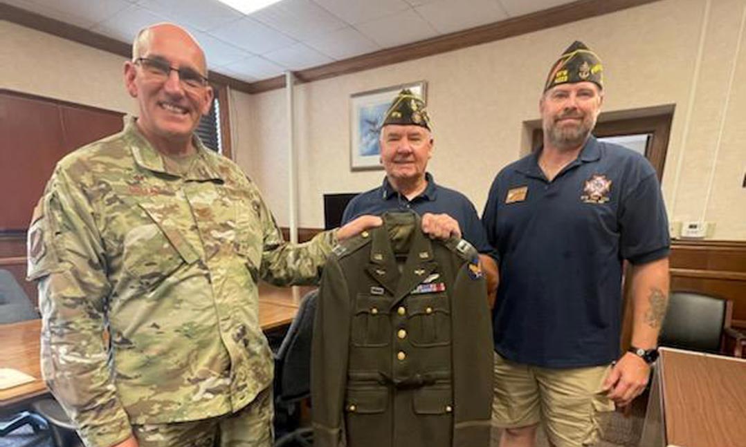 VFW Post 4223 members Noel Stasiak (center) and Brent Krohne (right) present an original captain’s Army Air Corps uniform to Air Force Col. William Miller