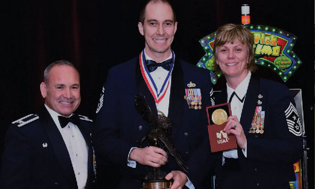 Jason Cvancara, center, receives an award for first sergeant of the year during the 944th Fighter Wing Awards Banquet