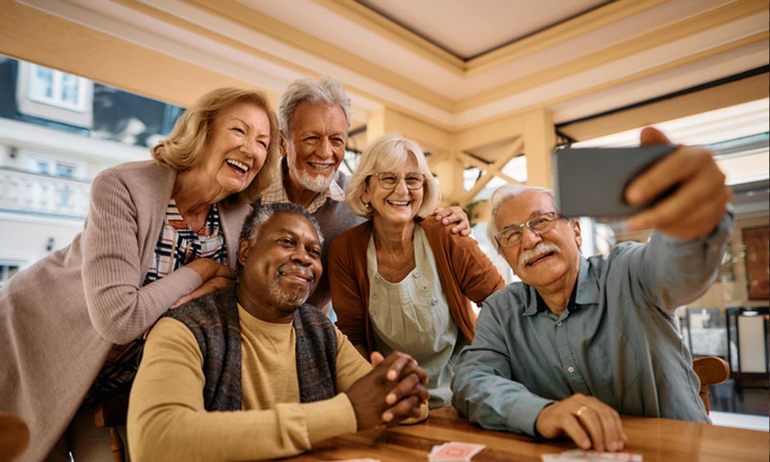 Group of older men and women smiling for a selfie