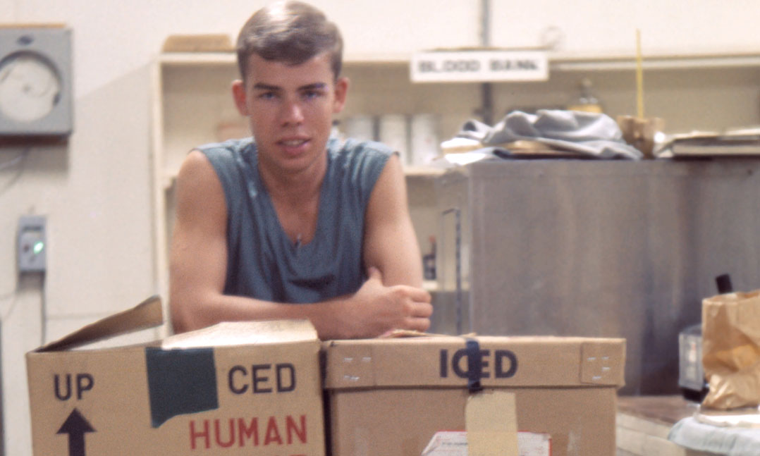 19-year-old Dave Buhr behind boxes of blood
