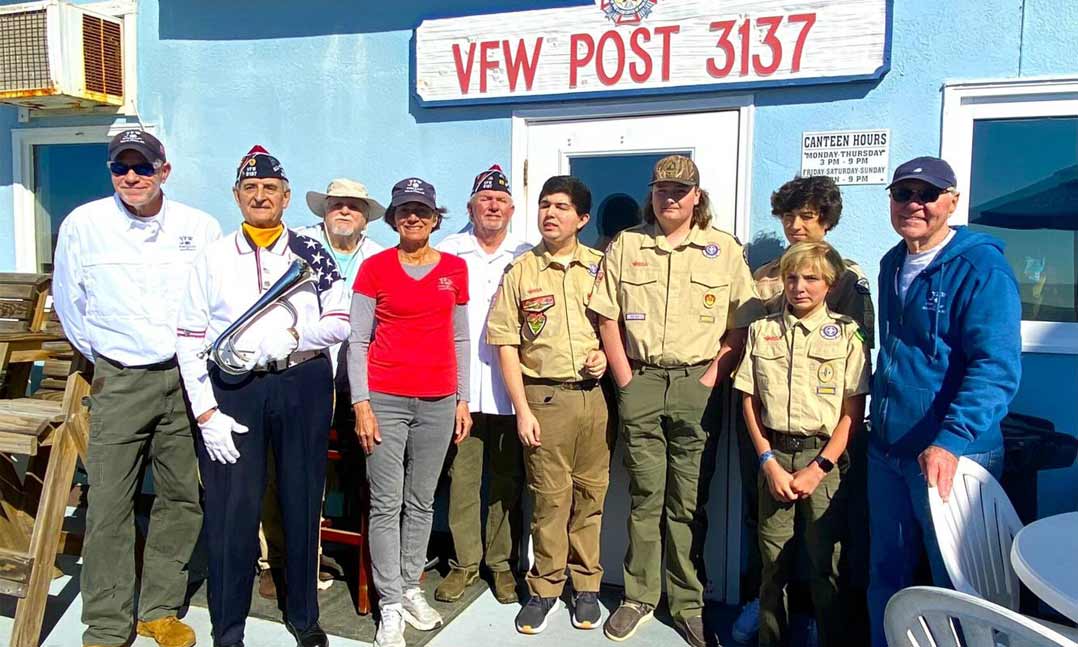 Post members stand with Boy Scouts for flag disposal