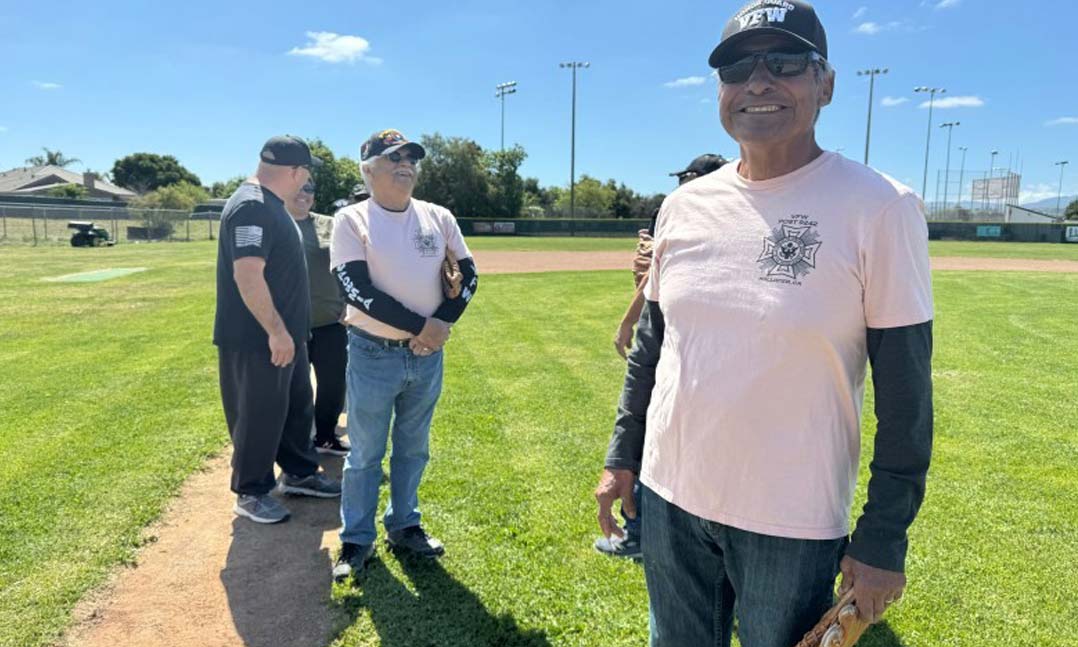 Hollister, Calif.’s VFW Post 9242 Commander Bernie Ramirez stands in the front ready to lead his team onto the field on April 27 to play against the San Benito Bambino team. 