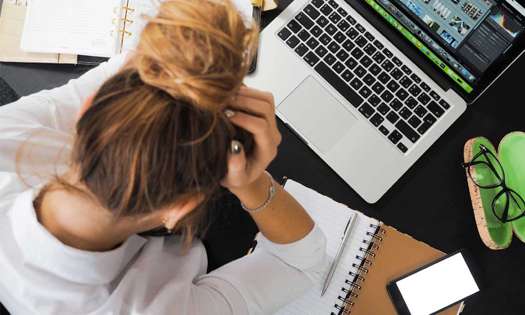 Woman Stressed About Bills in Front of Computer